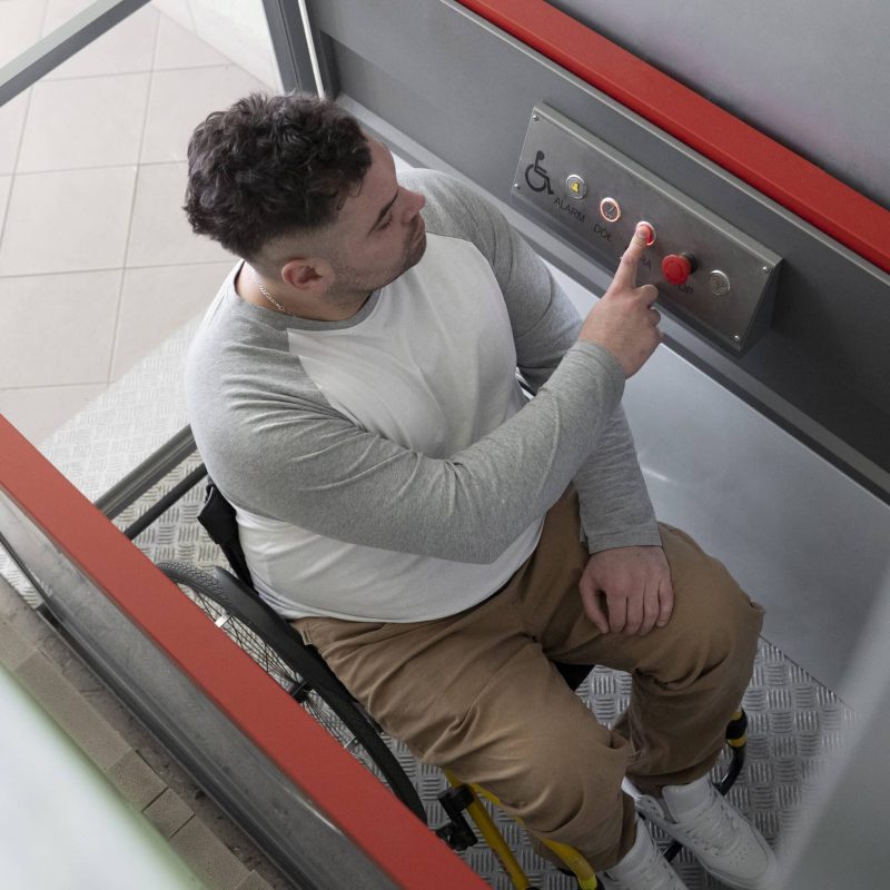 full-shot-man-wheelchair-using-elevator